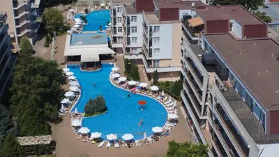 an overhead view of a large swimming pool with umbrellas at Top Studio in Big Kamelia Holiday Complex Sunny Beach in Sunny Beach