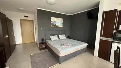 a bedroom with a bed with a pink towel on it at Top Studio in Big Kamelia Holiday Complex Sunny Beach in Sunny Beach