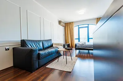 a living room with a couch and a bed at Bella boutique apartment in Sunny Beach