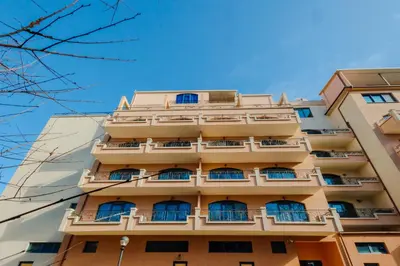 a tall apartment building with windows at Bella boutique apartment in Sunny Beach