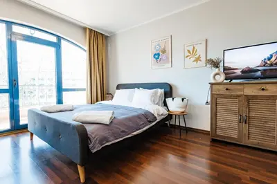 a bedroom with a bed and a large window at Bella boutique apartment in Sunny Beach