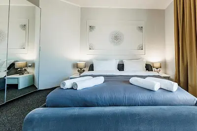 a bedroom with a large blue bed with two pillows at Bella boutique apartment in Sunny Beach