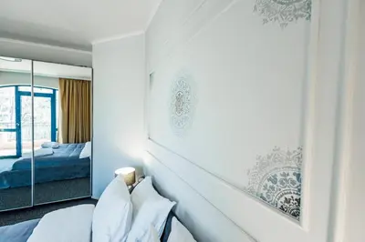 a bedroom with a bed and a mirror at Bella boutique apartment in Sunny Beach