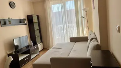 a living room with a large bed and a television at 2 Room Apartment in Luxury Complex Sunny Beach in Sunny Beach