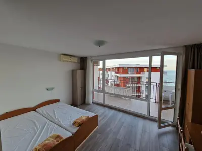 a bedroom with a bed and a large window at Studio Robinson Beach Sea Nessebar View in Sveti Vlas
