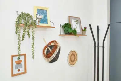 a wall with plants and pictures on it at Batak Studio in Burgas City