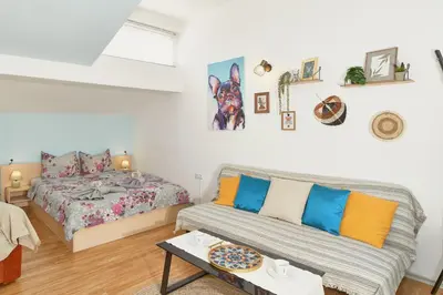 a living room with a couch and a bed at Batak Studio in Burgas City
