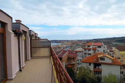 a view of a city from the balcony of a building at Модерен апартамент в сърцето на Созопол in Sozopol