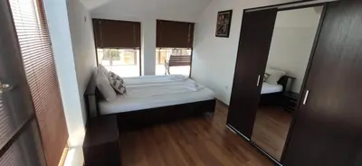 a small room with a bed and a mirror at Модерен апартамент в сърцето на Созопол in Sozopol