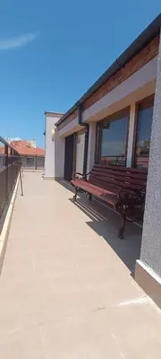 a bench sitting on the side of a building at Модерен апартамент в сърцето на Созопол in Sozopol
