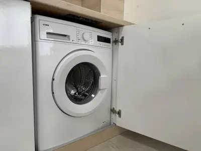 a white washing machine in a white laundry room at HORIZON Apartment 8,1 'A' Sveti Vlas in Sveti Vlas