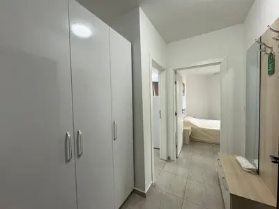 a hallway with white cabinets and a bedroom at HORIZON Apartment 8,1 'A' Sveti Vlas in Sveti Vlas