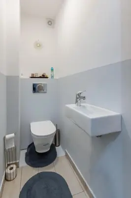 a white bathroom with a sink and a toilet at Happy Lazur in Burgas City