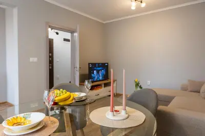 a living room with a glass table with two candles at Happy Lazur in Burgas City