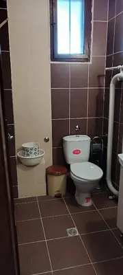 a bathroom with a toilet and a sink at Anchors Guest House in Sozopol