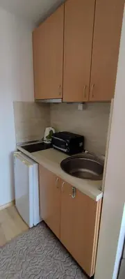 a small kitchen with a sink and a microwave at Anchors Guest House in Sozopol