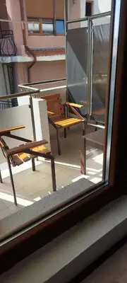 a view of a patio with a chair and a table at Anchors Guest House in Sozopol