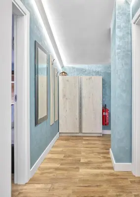 an empty hallway with blue walls and wooden floors at Perfect Seaside Retreat in Sveti Vlas Relax Complex by Flat Mаnаger in Sunny Beach