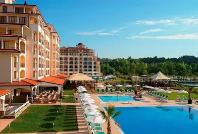 a resort with a swimming pool and a hotel at Сънрайз Данаилов in Obzor