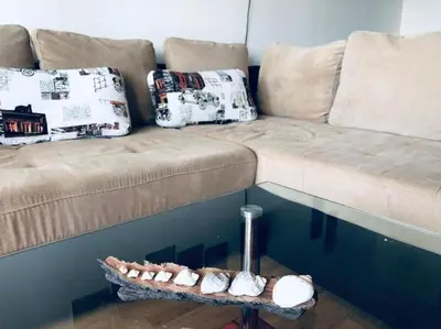 a living room with a couch and a table at Сънрайз Данаилов in Obzor