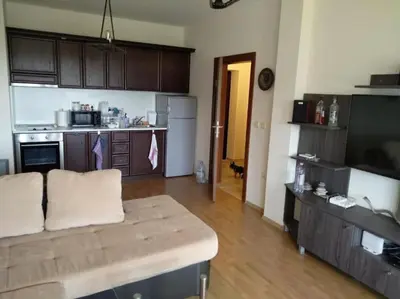 a living room with a couch and a kitchen at Сънрайз Данаилов in Obzor