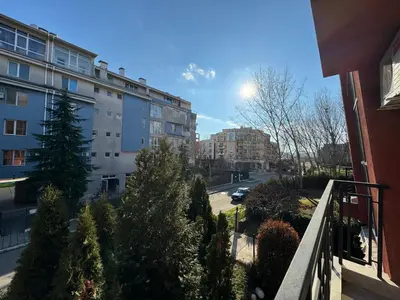 a balcony of a building with trees and a street at AFRODITA II - 19 Studio Sunny Beach in Sunny Beach