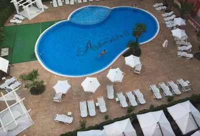 an overhead view of a swimming pool with chairs and umbrellas at AFRODITA II - 19 Studio Sunny Beach in Sunny Beach