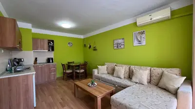 a living room with a couch and a table at KASANDRA 'Д' 5 Apartment Sunny Beach in Sunny Beach