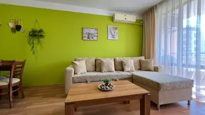 a green living room with a couch and a table at KASANDRA 'Д' 5 Apartment Sunny Beach in Sunny Beach