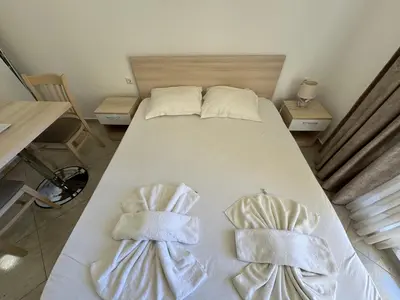 a bedroom with a bed with towels on it at HORIZON 7 'А' Studio Sveti Vlas in Sveti Vlas
