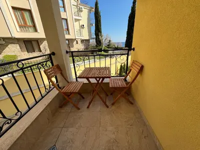 two chairs and a table on the balcony of a building at HORIZON 7 'А' Studio Sveti Vlas in Sveti Vlas