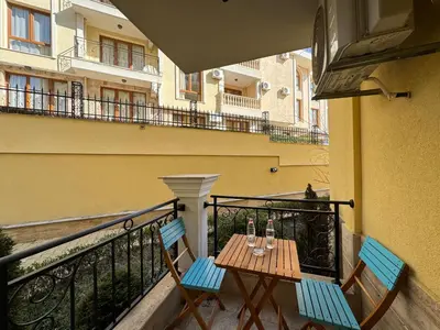 a balcony with two chairs and a table with drinks on it at HORIZON 1 'A' APARTMENT Sveti Vlas in Sveti Vlas
