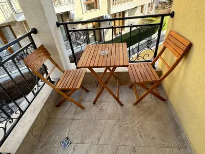two wooden chairs and a table on a balcony at HORIZON 12 'A' APARTMENT Sveti Vlas in Sveti Vlas