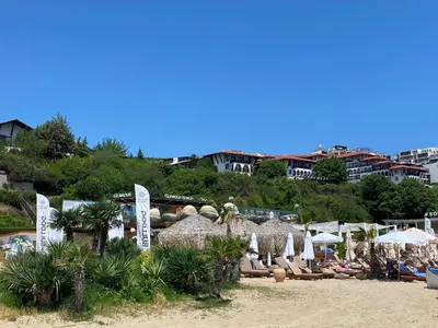 a beach with a bunch of umbrellas and chairs at HORIZON 13 'A' APARTMENT Sveti Vlas in Sveti Vlas