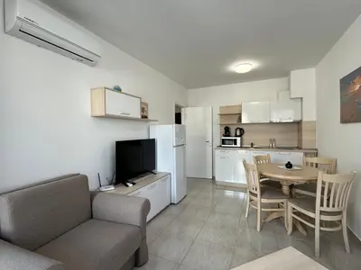 a living room with a couch and a table and a kitchen at HORIZON 19 'A' APARTMENT Sveti Vlas in Sveti Vlas
