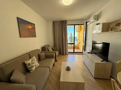 a living room with a couch and a tv at HORIZON 20 'A' APARTMENT Sveti Vlas in Sveti Vlas