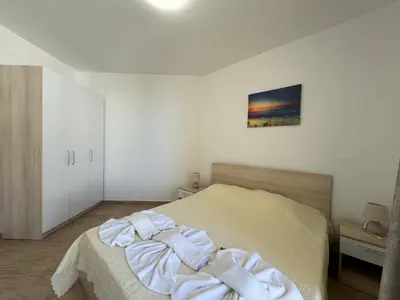 a bedroom with a bed with towels on it at HORIZON 20 'A' APARTMENT Sveti Vlas in Sveti Vlas