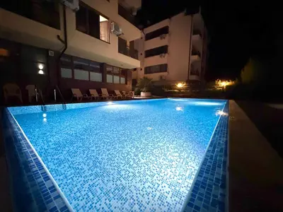 a large swimming pool in a building at night at Home by the Sea in Burgas City