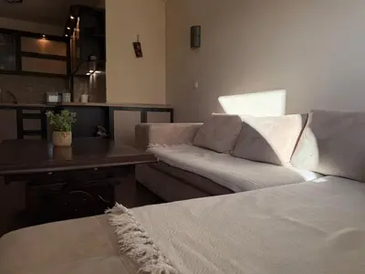 a living room with a couch and a table at Home by the Sea in Burgas City