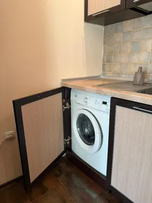 a kitchen with a washing machine in a kitchen at Home by the Sea in Burgas City