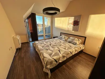 a bedroom with a bed and a large window at Home by the Sea in Burgas City