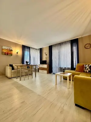 a living room with a couch and a table at Blue Marine - Daneli Apartment in Sunny Beach