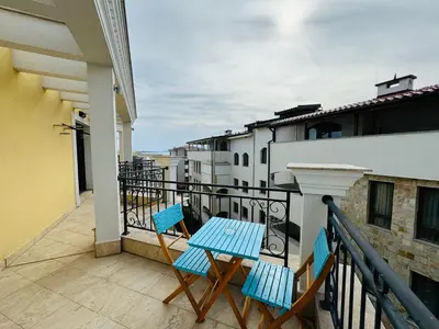 a balcony with two chairs and a table at HORIZON 38 'Б' Studio Sveti Vlas in Sveti Vlas