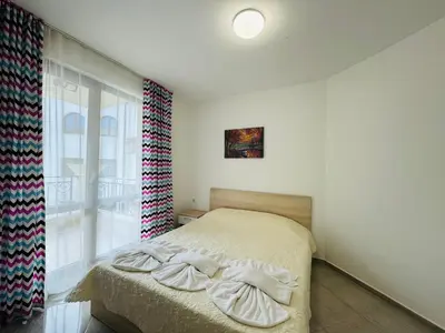 a bedroom with a bed and a large window at HORIZON 31 'Б' Apartment Sveti Vlas in Sveti Vlas