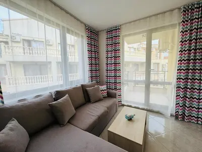 a living room with a couch and a table at HORIZON 25 'Б' Apartment Sveti Vlas in Sveti Vlas