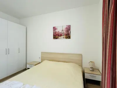 a bedroom with a bed and a picture on the wall at HORIZON 20 'Б' Apartment Sveti Vlas in Sveti Vlas