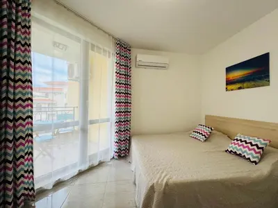 a bedroom with a bed and a large window at HORIZON 20 'Б' Apartment Sveti Vlas in Sveti Vlas