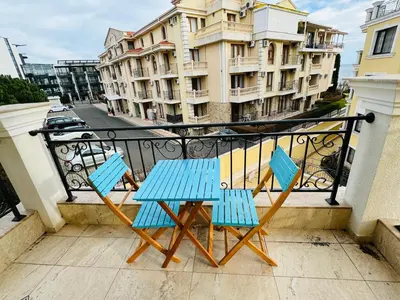 a blue table and two chairs on a balcony at HORIZON 20 'Б' Apartment Sveti Vlas in Sveti Vlas