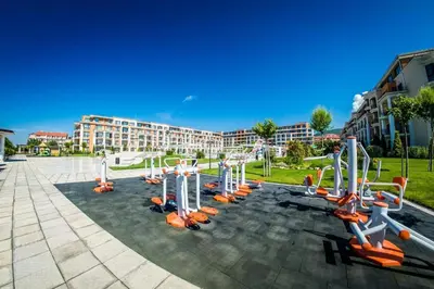a gym with exercise equipment in a park at Seaside Serenity Studio - Premier Fort Beach in Sveti Vlas