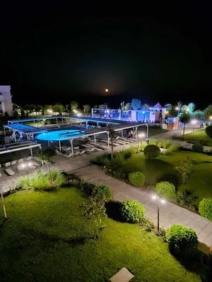 a swimming pool at night with lights in a park at Seaside Serenity Studio - Premier Fort Beach in Sveti Vlas